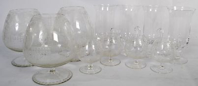 A set of 3 crystal glass brandy goblets having chase decorated garden and crinoline scenes together