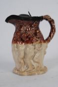 A circa 19th century Biscuitware jug with pewter lid depicting cherubs and animals.