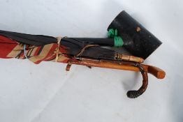 A large Irish Shillelagh walking stick / club along with a vintage childs umbrella and 2 others.