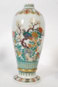 An 18th century Chinese enamel painted famille rose vase of baluster from decorated by hand with