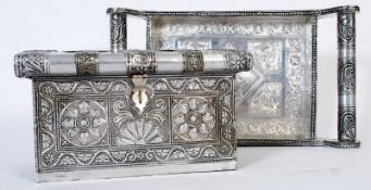 An ornate Indian white metal silver tray with foliate handles along with an Indian white metal