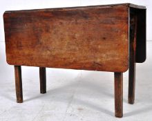 A Georgian solid mahogany drop flap dining table raised on squared legs with drop leaves to either