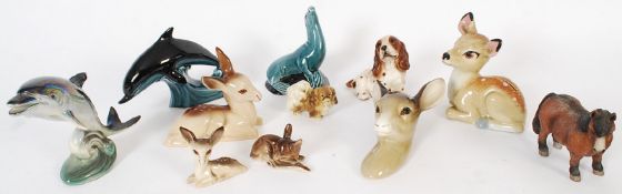 A collection of ornaments to include deers, and Poole dolphins.