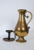 A 19th century chamber candlestick together with a large brass 1914 wartime water jug both being