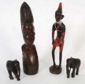 Two African heads and two small wooden elephants.