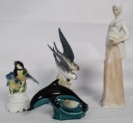 A Zaphie Swallows figurine (15cm tall), a Poole Pottery dolphin (12cm tall), a Tengra figurine of a