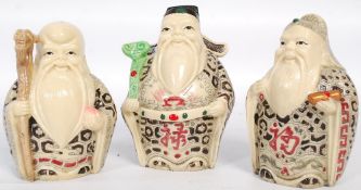 Three 20th century resin figurines of chinese / oriental characters.