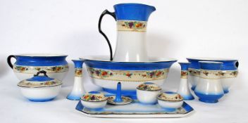 A complete Kiralpo Ware Staffordshire dressing table set, including wash jug and basin, potties,