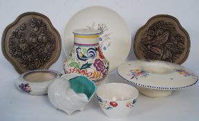 An assortment of Poole pottery to include Spring, Summer, plaques and other items.
