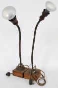 A pair of 1930`s anglepoise industrial lamps set on wooden bases with sprung arms rising to the