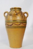 A large stoneware ewer of continental origin having handpainted decoration