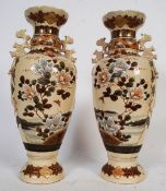 A pair of 20th century Satsuma Japanese vases with hand painted decoration and temple dog handles.