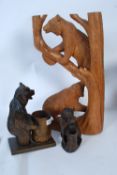 Two Black Forest style carved wooden bears, along with another large carved wooden statue of two
