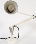 An original white Herbert Terry anglepoise light set on a circular weighted base, spring cantilever