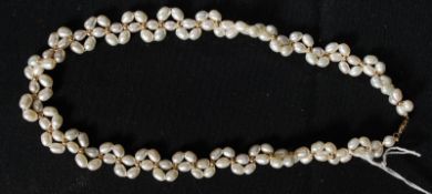 A baroque pearl necklace with a 14ct yellow gold clasp.