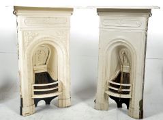 A pair of small 20th century cast iron painted bedroom fireplaces.
