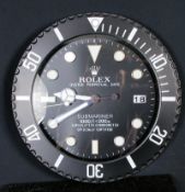 An advertising shop display wall clock, stamped Rolex to dial in black noir colouring.