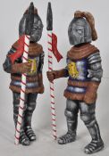 Two large decorative papier mache models of knights, for use in a garden or indoors.