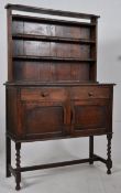 A 1930's oak sideboard dresser with earlier 19th century rack. Raised on barley twist legs united by