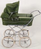 A 20th century large green corderoy silver cross pram in good condition with working hood, sat on