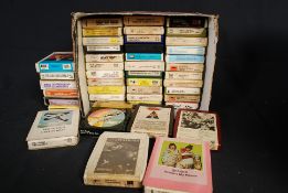 A collection of vintage retro 8 track music tapes.