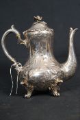 A 19th century Victorian rococo revival teapot raised on shaped legs having bulbous body with