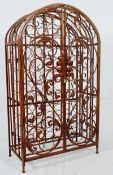 A contemporary large metal cage wine rack in the continental style having twin doors with lock and