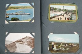 An album postcards dating from the early 20th century to include photocards, views and greetings,