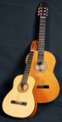 A Spanish acoustic guitar marked Guitarras Cuenca along with a half size guitar by Hirald.