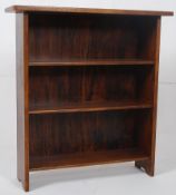 A mid 20th century solid mahogany open window dwarf bookcase. Fixed shelves with flared top above