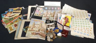 A mixed lot of coins, sheets of stamps, vintage stamp albums, medallion and teacards etc.