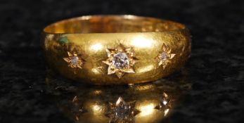 An 18ct yellow gold diamond set gypsy style ring. 3g