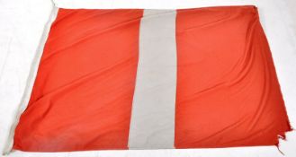 A large 20th century flag, with bold white striped centre.
