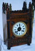 An oak cased Castle gothic style galleried mantel clock striking on a gong