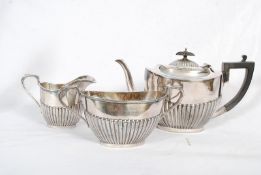 An Art Deco silver plate teapot along with a milk jug and cream boat by Harrison Fisher & Co,