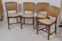A set of 4 walnut 1930's Art Deco dining chairs having beige faux leather upholstered drop in