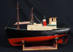 A good model / radio controlled boat, in the theme of a steamer tug, with original plinth.