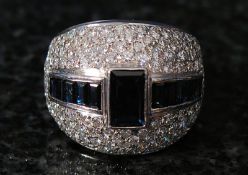 An 18ct white gold Art Deco style diamond and sapphire ring. 9.6g