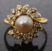 An 18ct gold diamond and freshwater pearl solitaire ring. The large freshwater pearl set within a