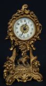 A late 19th century gilt metal enamel faced mantel clock by Waterbury USA.