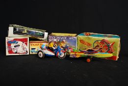 A collection of vintage tinplate toys to include motorcycle and side car, rocket and vespa bike.