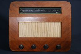 a 1940's Murphy radio transistor in walnut case with clean facia and upholstered speaker front.