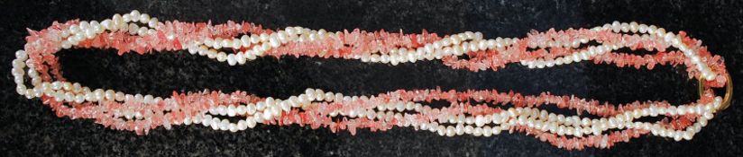 A long cream necklace with freshwater pearls and rose quartz.