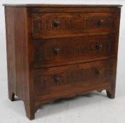 A 20th century Jacobean revival oak low chest of drawers. Each drawers with carved details having