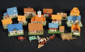 A 1920's German made toy model village with wooden buildings, animals and vehicles etc