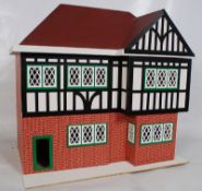 A Hobbies dolls house in mock tudor styling with faux red bricked walls.