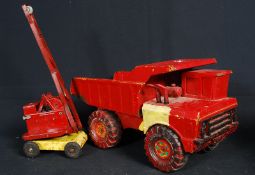 A vintage Cohen tinplate toy crane along with a later Tonka building truck.