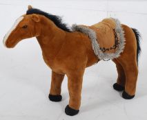 A large toy horse teddy having speaking / neighing action with saddle being supportive for small