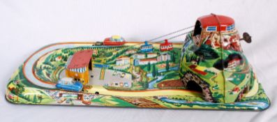 A mid 20th century tin plate DGBM cable car and car clockwork track set. Made in West German. The