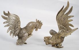 A pair of silver plate fighting cocks display ornament.  Measures 18cms High